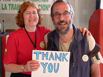 Two people holding 'Thank You' sign